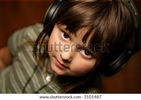 Adorable five year old wearing headphones.