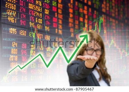 business woman open hand showing graph in stock exchange board