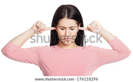 Young woman holding her fingers in her ears, isolated on white