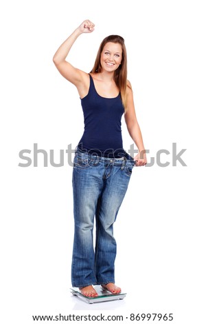 Young woman delighted with her dieting results, isolated on white