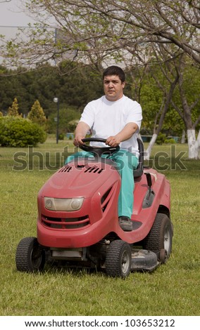 Ride-on lawn mower cutting grass