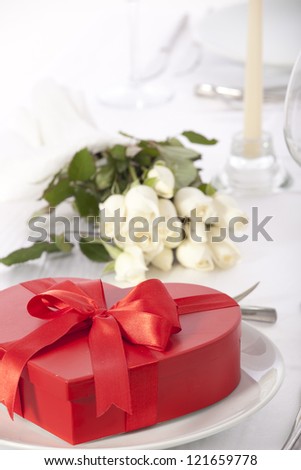 Romantic table setting with rose and chocolate box valentines day