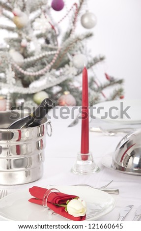 Romantic table setting with rose and cutlery at christmas