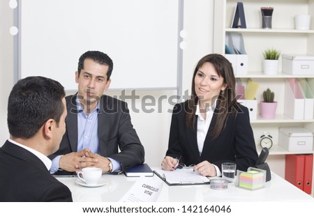man explaining about her profile to business managers at a job interview