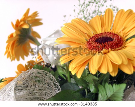 Lower angle of a flower bouquet with two yellow Daisies and a white Rose
