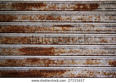 Background photo of a rusty old iron rolling shutter