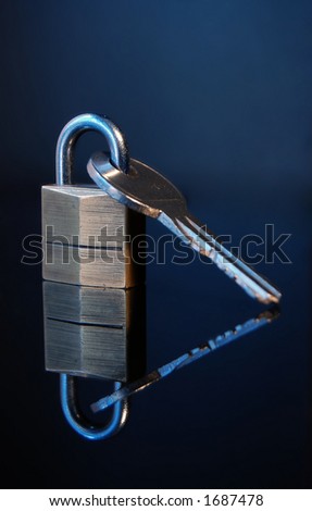 House key with lock on dark background