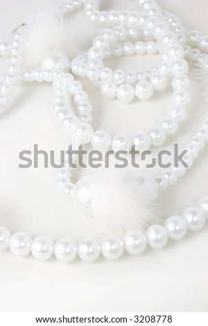 Pearl necklace over white background, high key shot