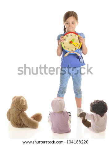 A attractive young elementary girl teaching her toys to tell time.  On a white background with plenty of space on the left for your text.