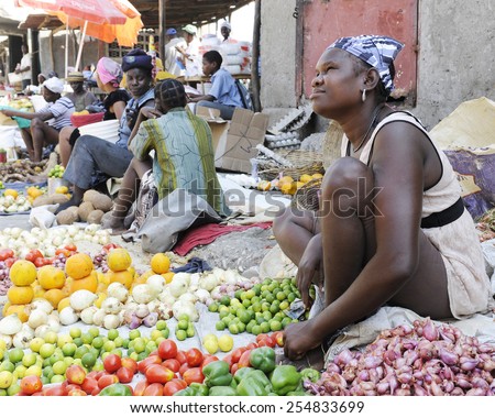SAINT MARC, HAITI - FEBRUARY 22, 2013:  Women selling fruits and veggies along the street in St. Marc, Haiti.