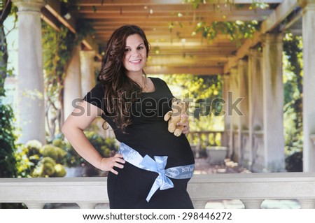 A pregnant mom happily wearing a \