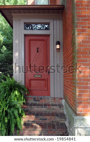 An attractive red entry to an old brick house.