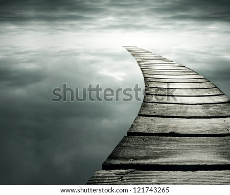 Beautiful conceptual background with a wooden path in to the infinity dramatic sky