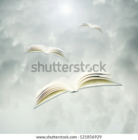Fantasy background represent three opened books like birds in flight in a cloudy sky