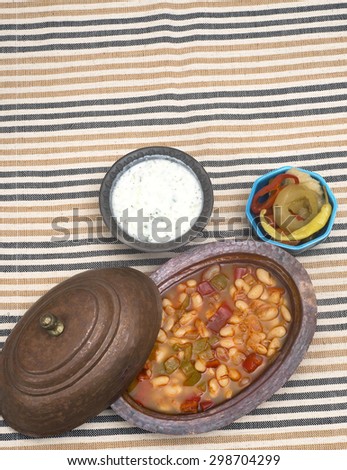Turkish traditional meal, beans, rice, mixed pickles and tzatziki