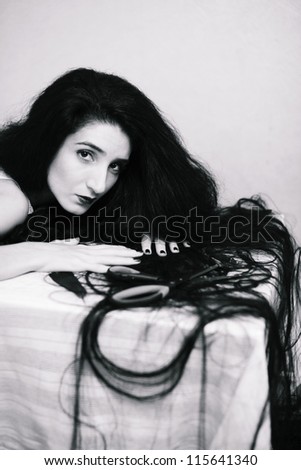 beauty girl cuting her hair in empty fearing room