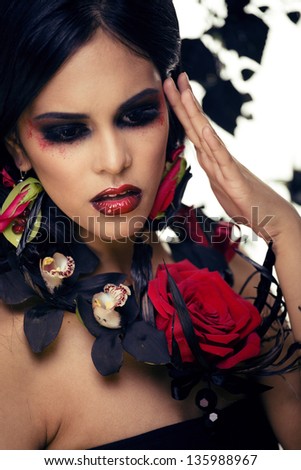 pretty brunette woman with rose jewelry, black and red