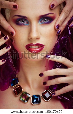 beauty woman with creative make up, many fingers on face close up