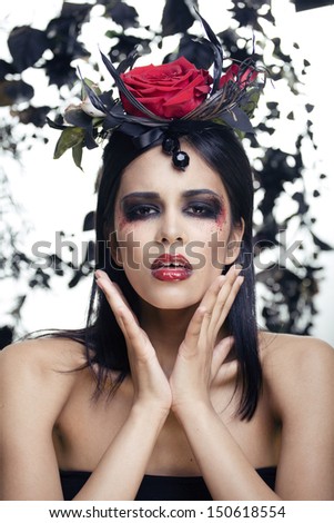 pretty brunette woman with rose jewelry, black and red, bright make up kike a vampire
