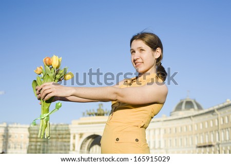 happy  woman holding flowers meeting friend