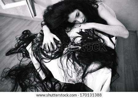 beauty girl cuting her hair in empty fearing room with cutted hair