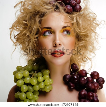 beautiful young woman portrait excited smile with fantasy art hair makeup style, fashion girl with creative food fruit orange, grapes, citrus make up, happy looking at camera isolated white background