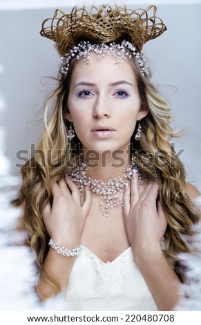 beauty young snow queen in fairy flashes with hair crown on her head