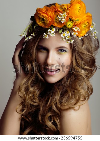 Beauty young woman with flowers and make up close up, real spring beauty girl curly hair