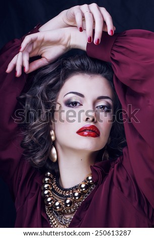 beauty rich brunette woman with a lot of jewellery, hispanic curly lady close up