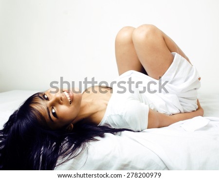 pretty real mulatto brunette woman in bed, cant sleep mad look
