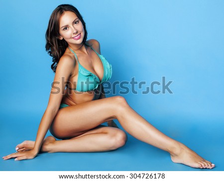 young pretty brunette girl in bikini smiling studio close up