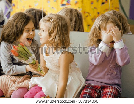three little diverse girls at birthday party having fun