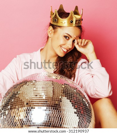 young cute disco girl like doll on pink background with disco ball and crown smiling
