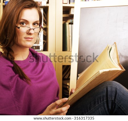 young teen girl in library among books emotional close up bookwarm