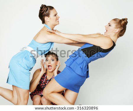 three elegant fashion woman fighting on white background, bright dresses