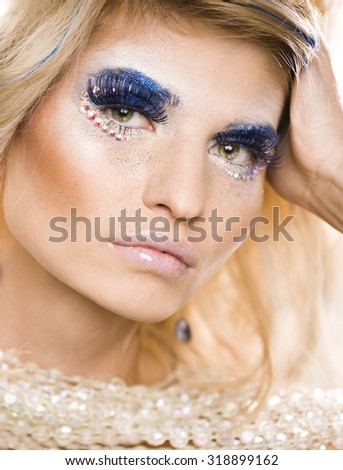 beauty young woman with creative make up bright shining