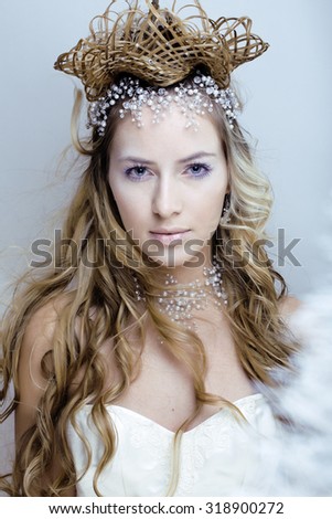 beauty young snow queen in fairy flashes with hair crown on her head close up frozen lashes