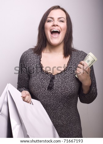 portrait of beautiful happy girl with money at shopping