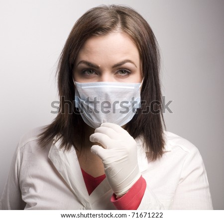 portrait of young beauty doctor in medical mask
