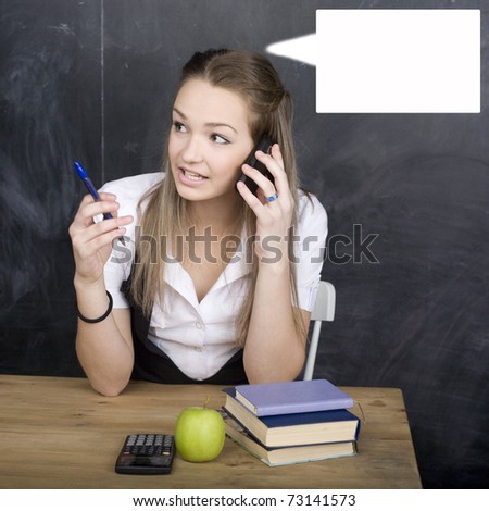 portrait of happy cute young student near blackboard with copy book calculator pen, copy space