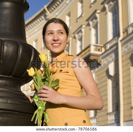 stock-photo-happy-woman-holding-flowers meeting friend