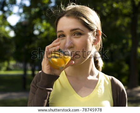 portrait of pretty young woman drinking juice, healthy lifestyle