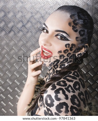 close-up portrait of beautiful young european model in cat make-up and bodyart