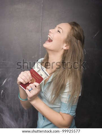 portrait of cute girl student with money and passport