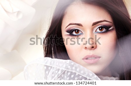 closeup portrait of a perfect young woman bride with bright makeup on blurred background with rose
