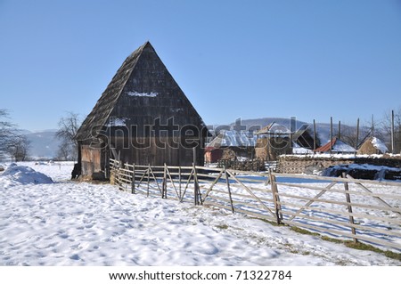 wood house and fence in the winter time