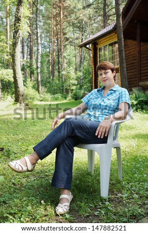 Woman is having rest in a coniferous forest