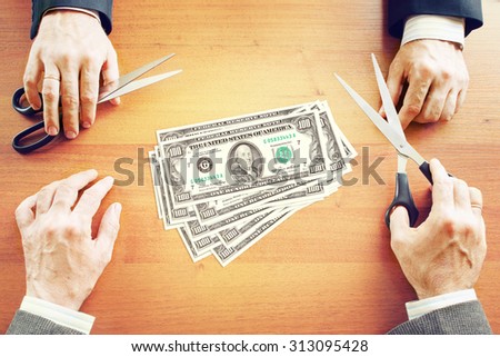 Two businessmen share profits. Conceptual image