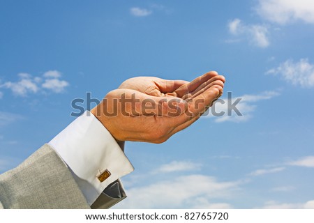 Business mans hands held to the heavens begging for more