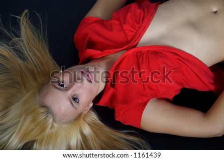 Lying blond woman with a red blouse